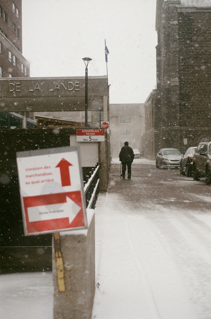 silhouette of an older man walking off the street into the Centre d'hébergement Jean-De-La-Lande