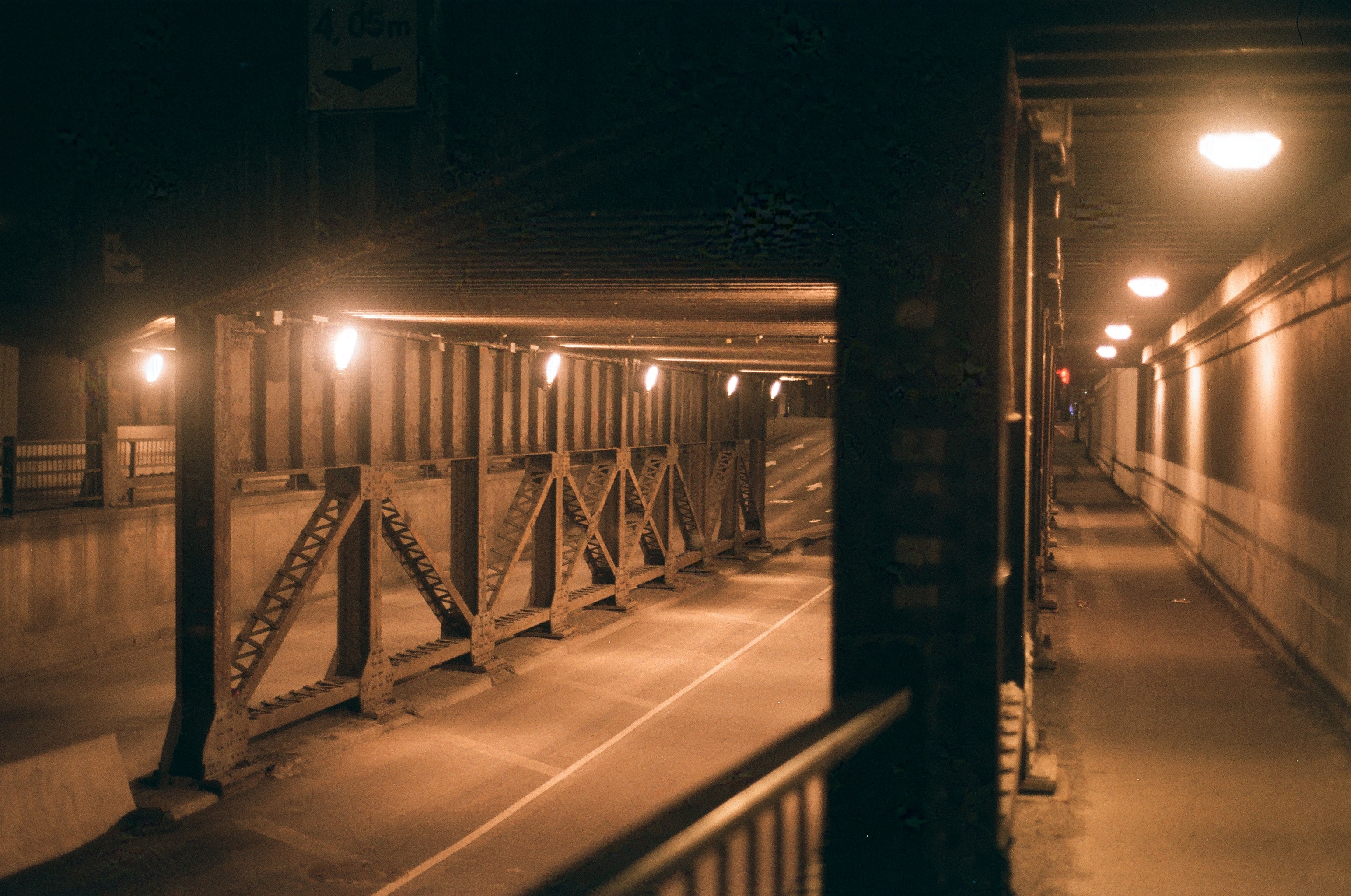 st.-laurent street as it dips under the railway, lit by orange halogen