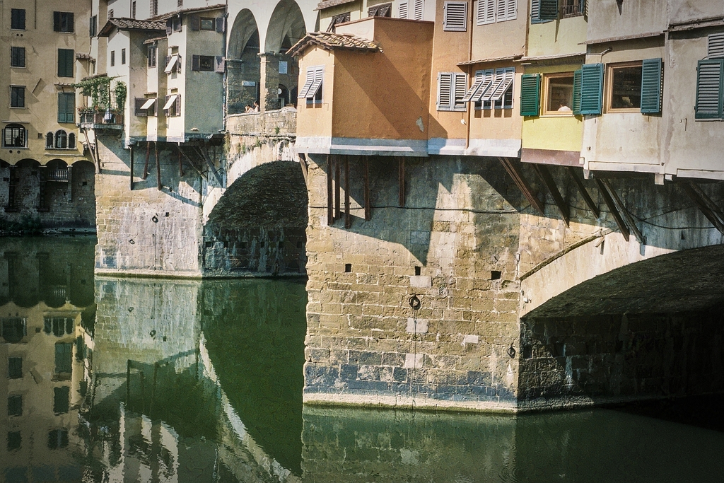 The Ponte Vecchio bridge in Florence, many buildings projecting out over the water