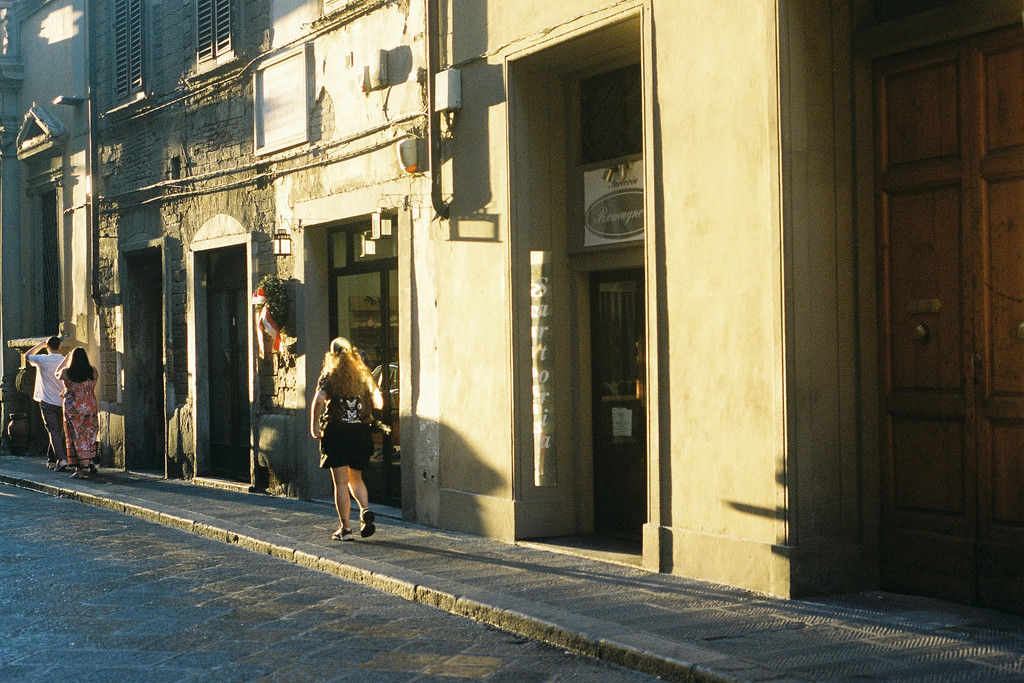 People walking along the narrow streets of Florence, at sunset