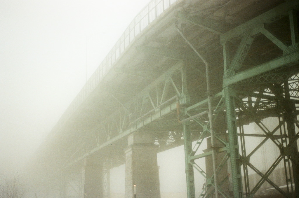 The underside of Jacques Cartier bridge, disappearing into the fog