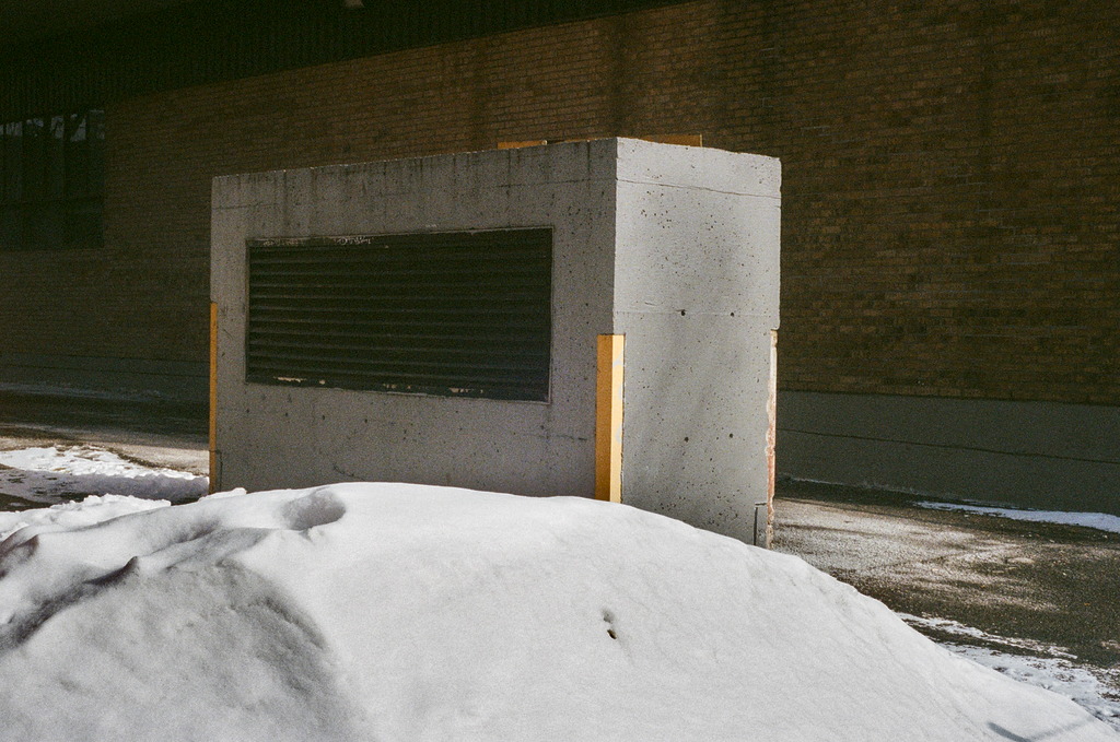 A concrete encasement covering an HVAC exhaust