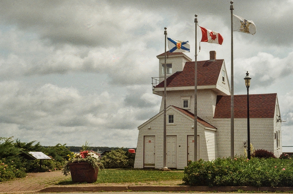 A short, squat little building with wooden siding