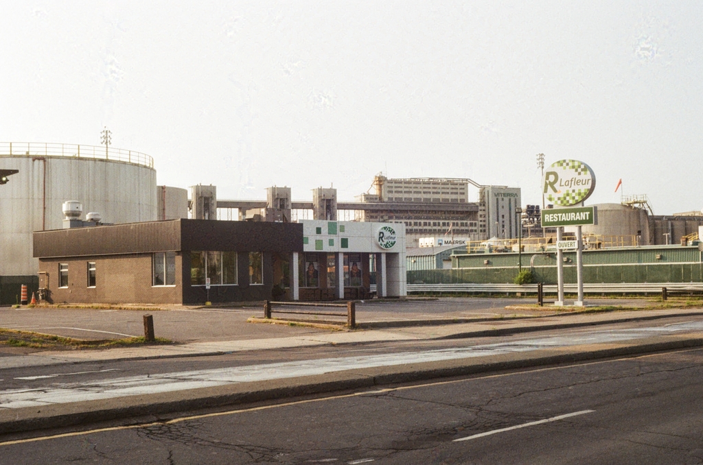 A Lafleurs restaurant, looking like a gas station among fuel refineries