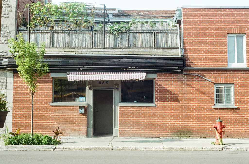 An awning casts shade over the entrance to a bar
