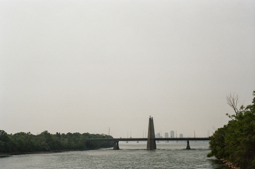 The twin spires of Pont des Îles under a very hazy sky