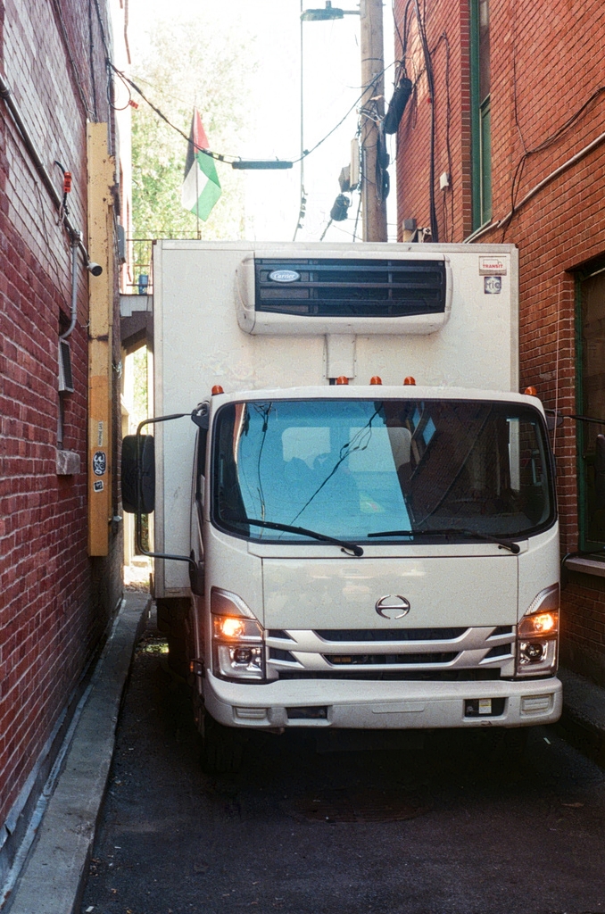 A delivery truck tucked in an alleway behind Fairmount Bagels. Free Palestine.