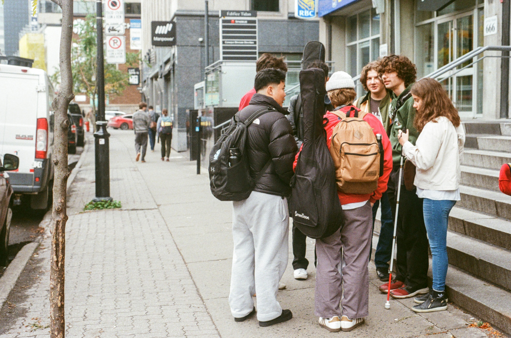 A few kids milling about in front of the Tim Hortons on Sherbrooke & University