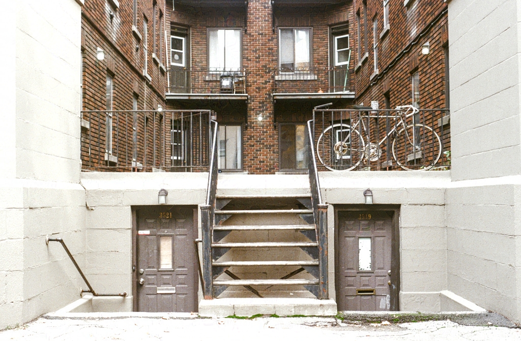 Stairs leading up to a small apartment courtyard