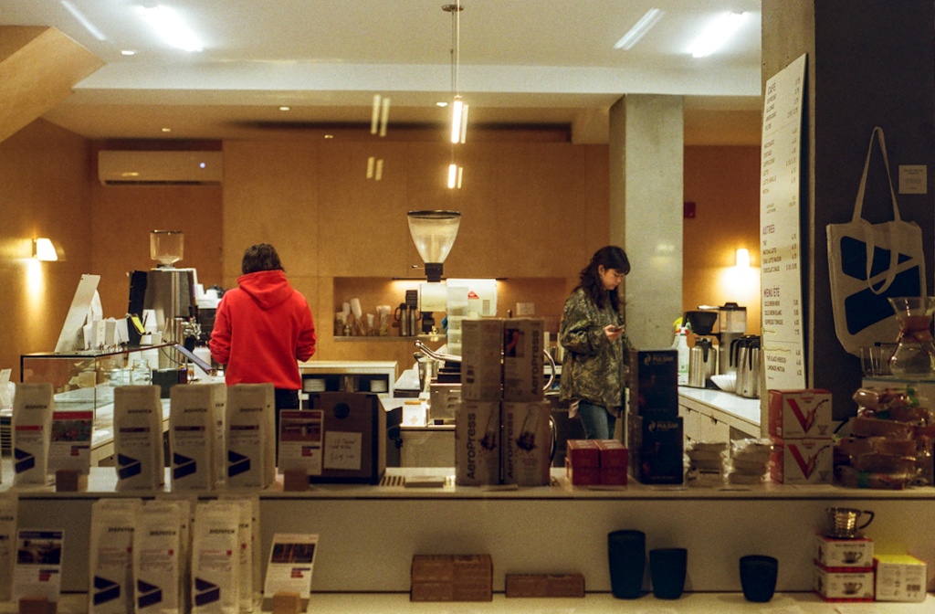 Two people in a kitchen goods shop window, closing for the night
