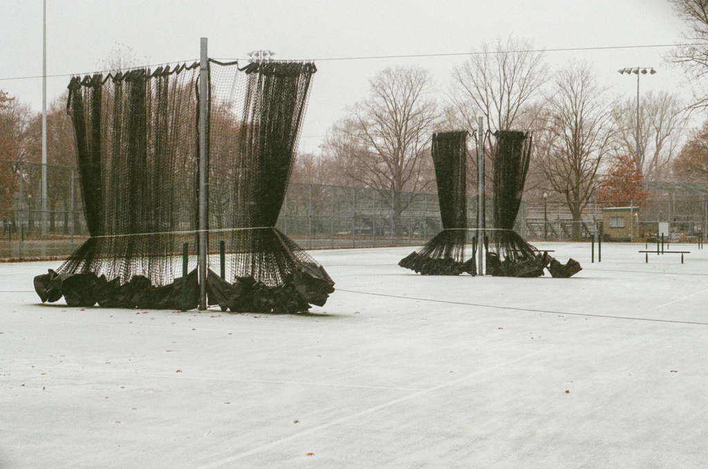 Dividing nets between tennis courts, tied up for the season