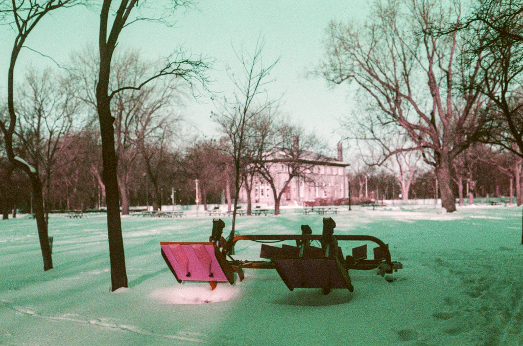A piece of winter machinery, possibly a plow, in the snow of Parc Lafontaine