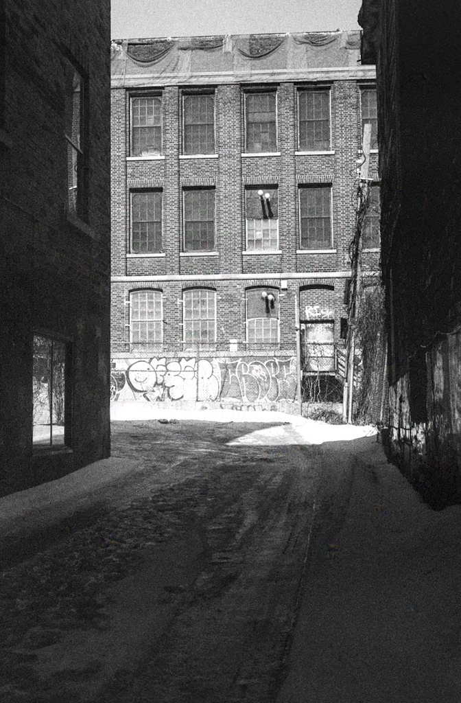 Brick warehouse seen through an alley