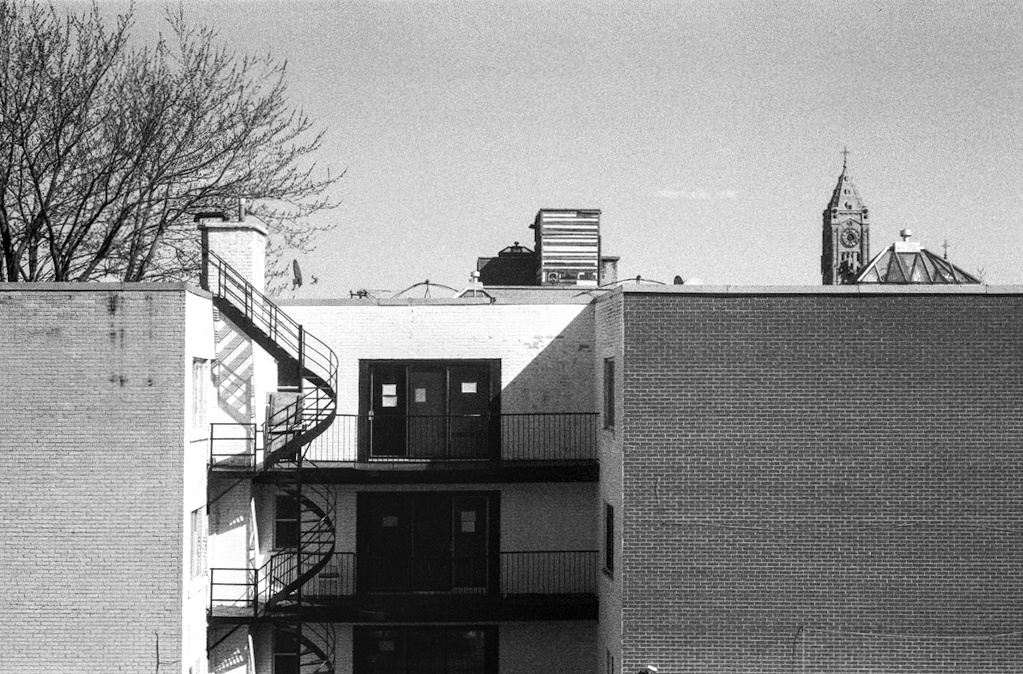 Balconies and a fire escape under slanting light