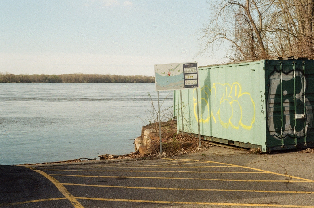 A green cargo container by a river