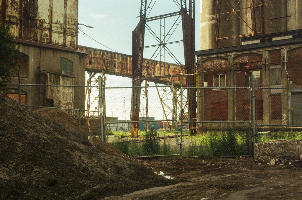Rusted-out warehouses, fences, and gangways
