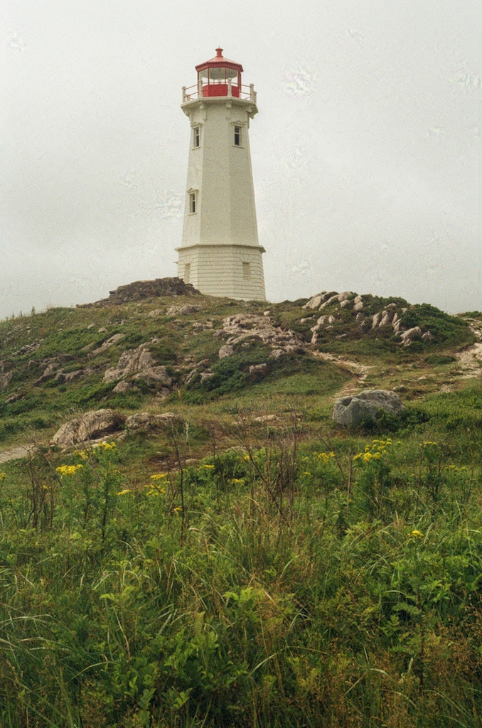 A lighthouse on a rocky hill