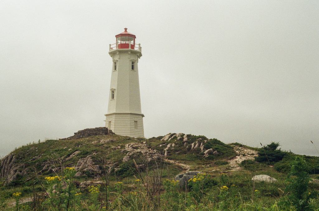 A lighthouse on a rocky hill