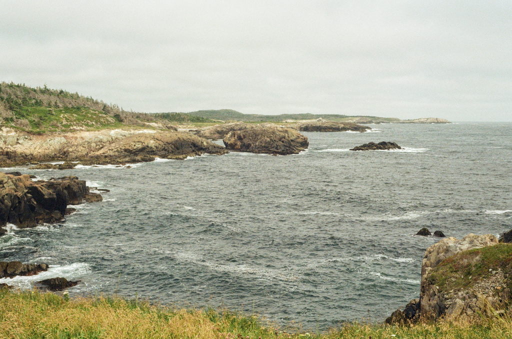 Waves entering a small bay, splashing on cliffs