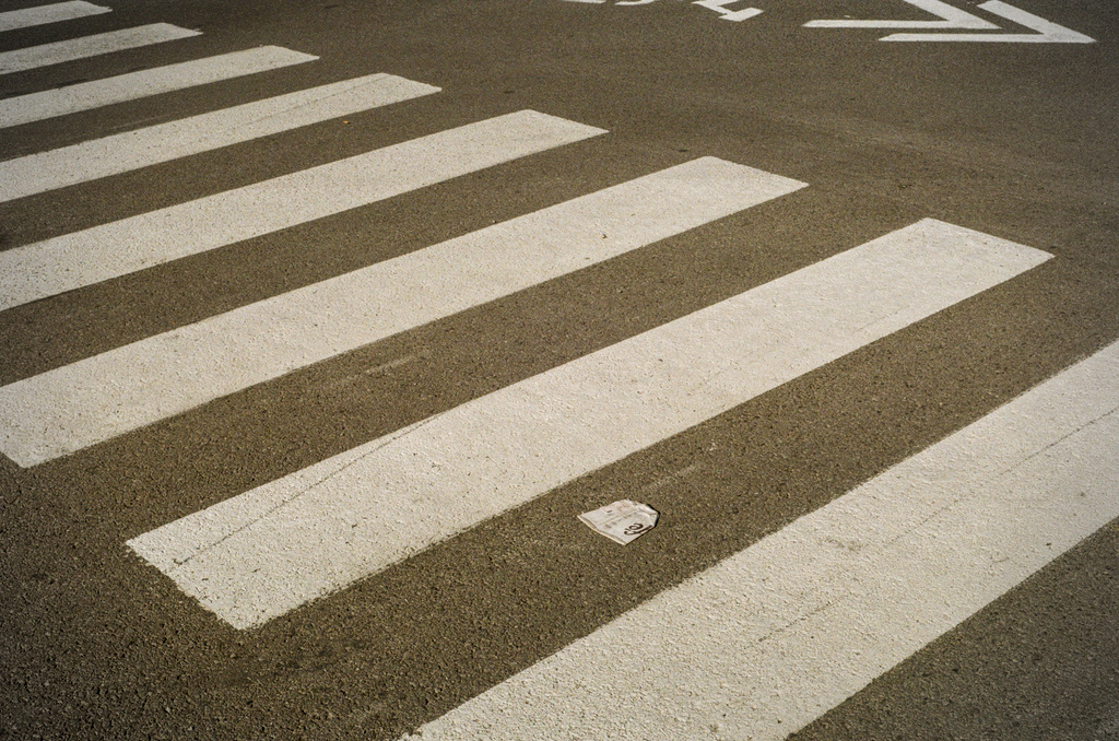 A crushed McCafé cup at a crosswalk